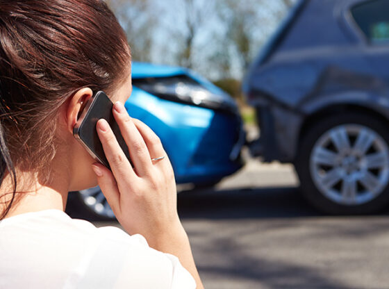 Woman on a phone after having a crash