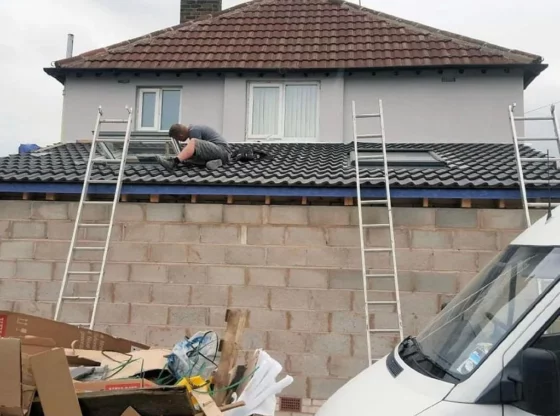 Roofer fixing the roof on a home