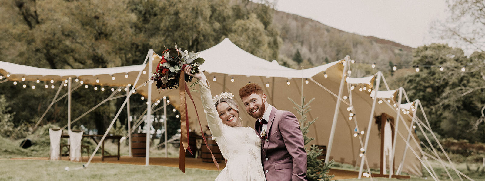 Bride and Groom in Front of a Large Stretch Tent