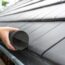 Man,Puts,A,Gutter,Mesh,To,The,Rain,Gutter,To