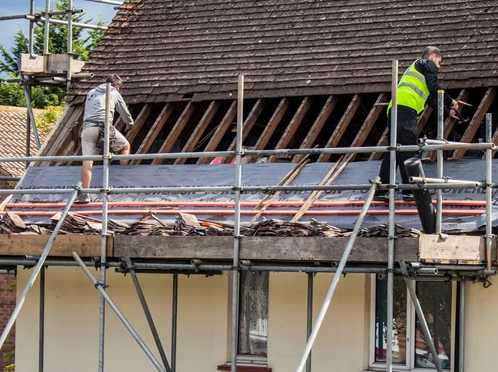 Roofers working on a broken site